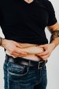 Person Pinching His Belly