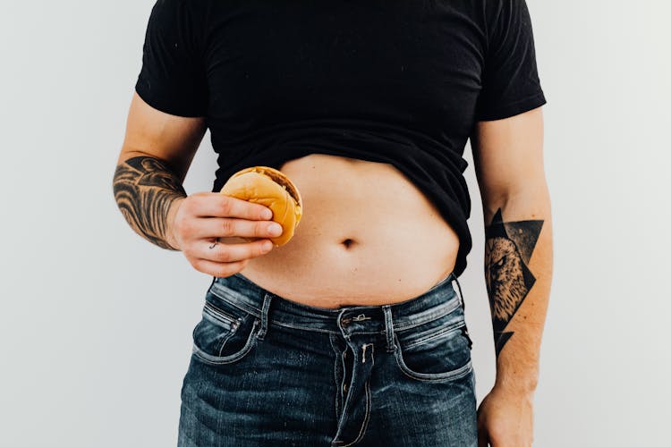 A Man Holding A Hamburger