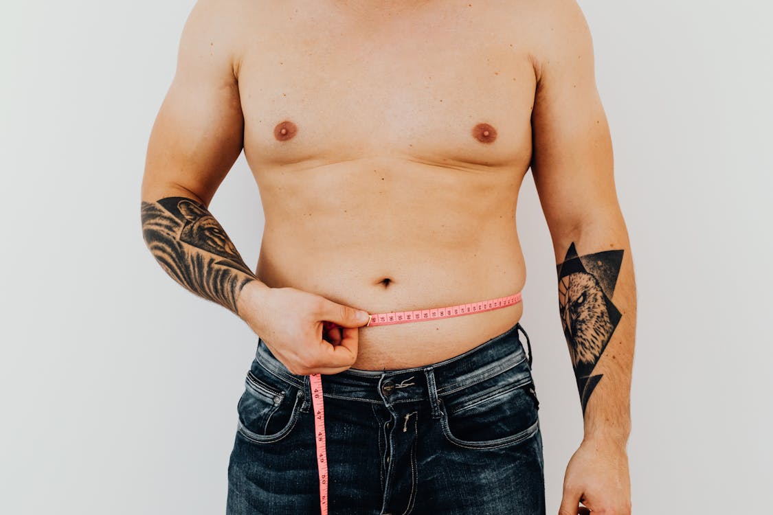 Free Man Measuring His Abdomen Stock Photo