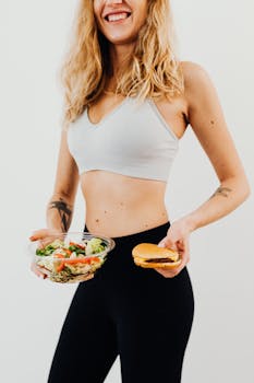 Smiling woman in sportswear balances healthy salad vs junk food choice.