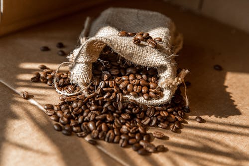 Free Close-up of Coffee Beans Spilling from a Bag Stock Photo