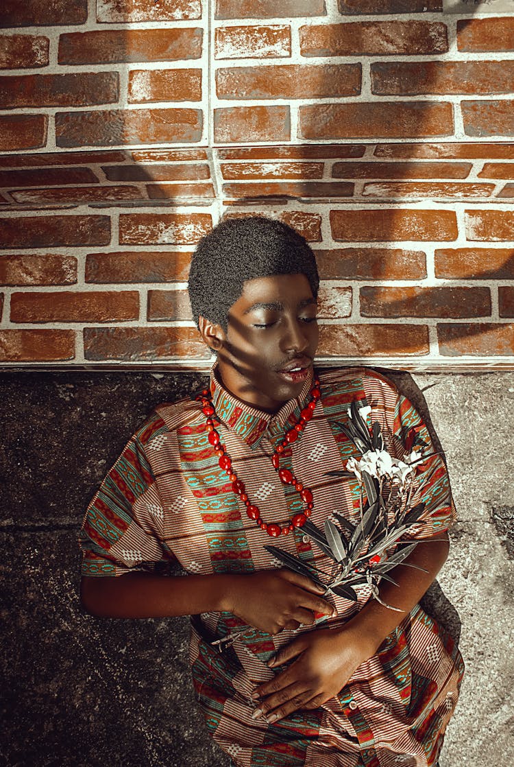 Calm Man With Flowers On Pavement