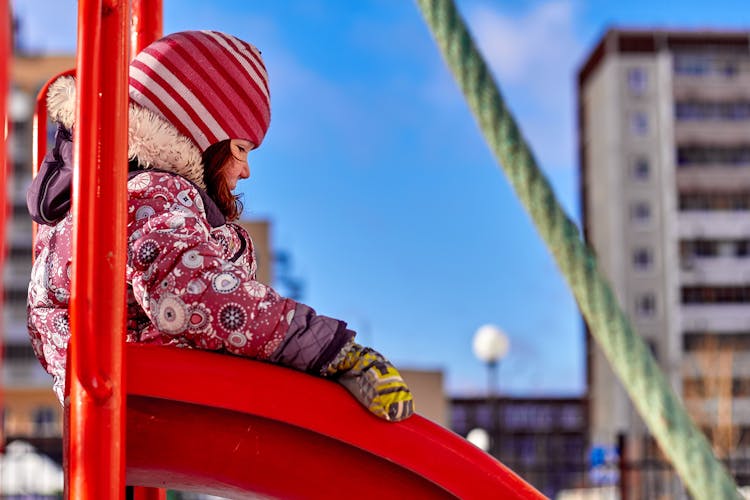 Girl On A Slide In Winter