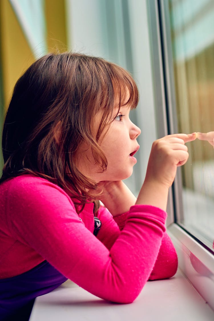 Curious Girl Looking Through Window