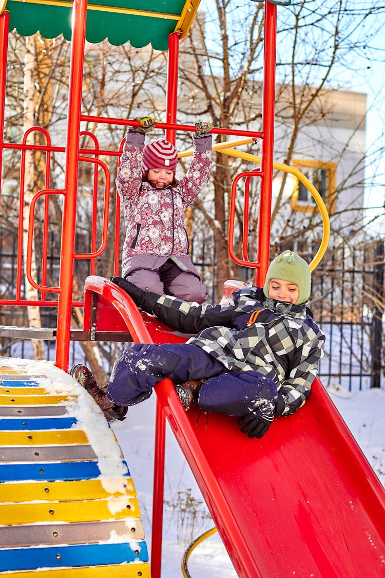 Children On A Slide In Winter