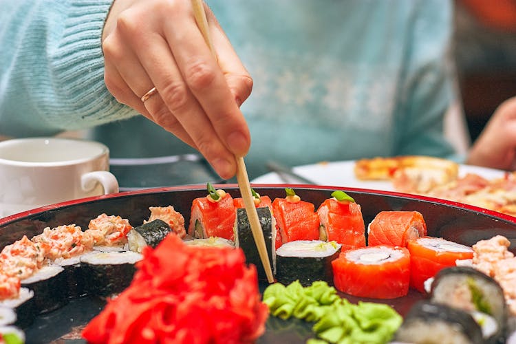Close-up Of Person Eating Sushi
