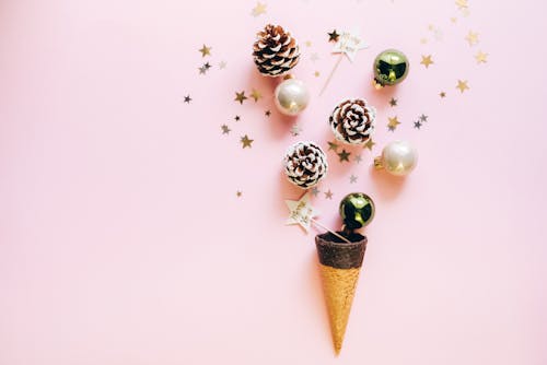 Flat Lay Photography of Christmas Ornaments on Pink Surface