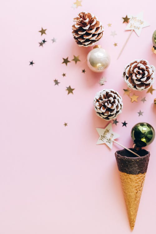 Flat Lay Photography of Christmas Ornaments on Pink Surface