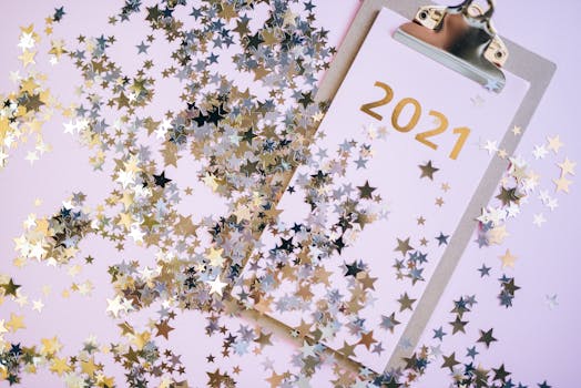 A festive New Year image with glitter stars on a 2021 clipboard, perfect for holiday decorations.
