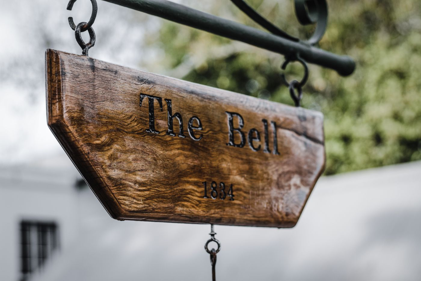 Engraved vintage wooden sign hanging outdoors