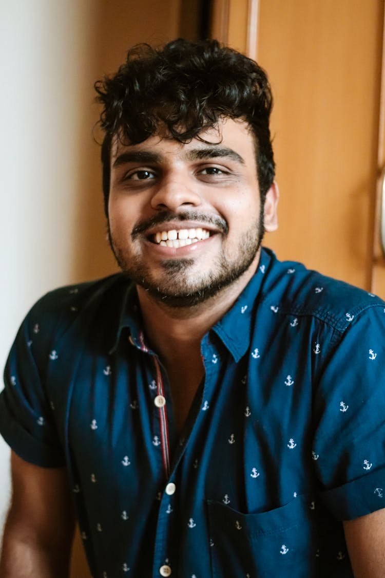 Portrait Of Smiling Man In Blue Shirt