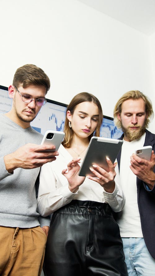 Man in Gray Sweater Holding Silver Iphone 6