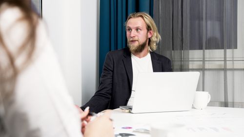 Person speaking to camera in an office by Artem Podrez on Pexels