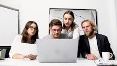 3 Women and Man Sitting Beside Table With Laptop Computer