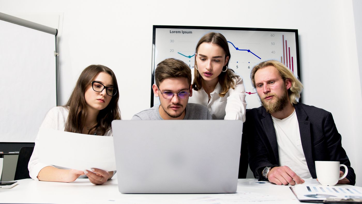 Project team reviewing plans on a laptop