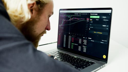 A Man Looking at the Data on the Computer Screen