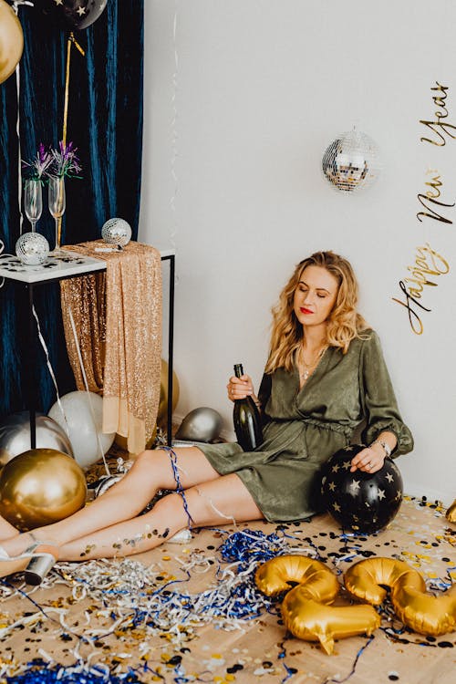 Woman Sitting with Wine Bottle