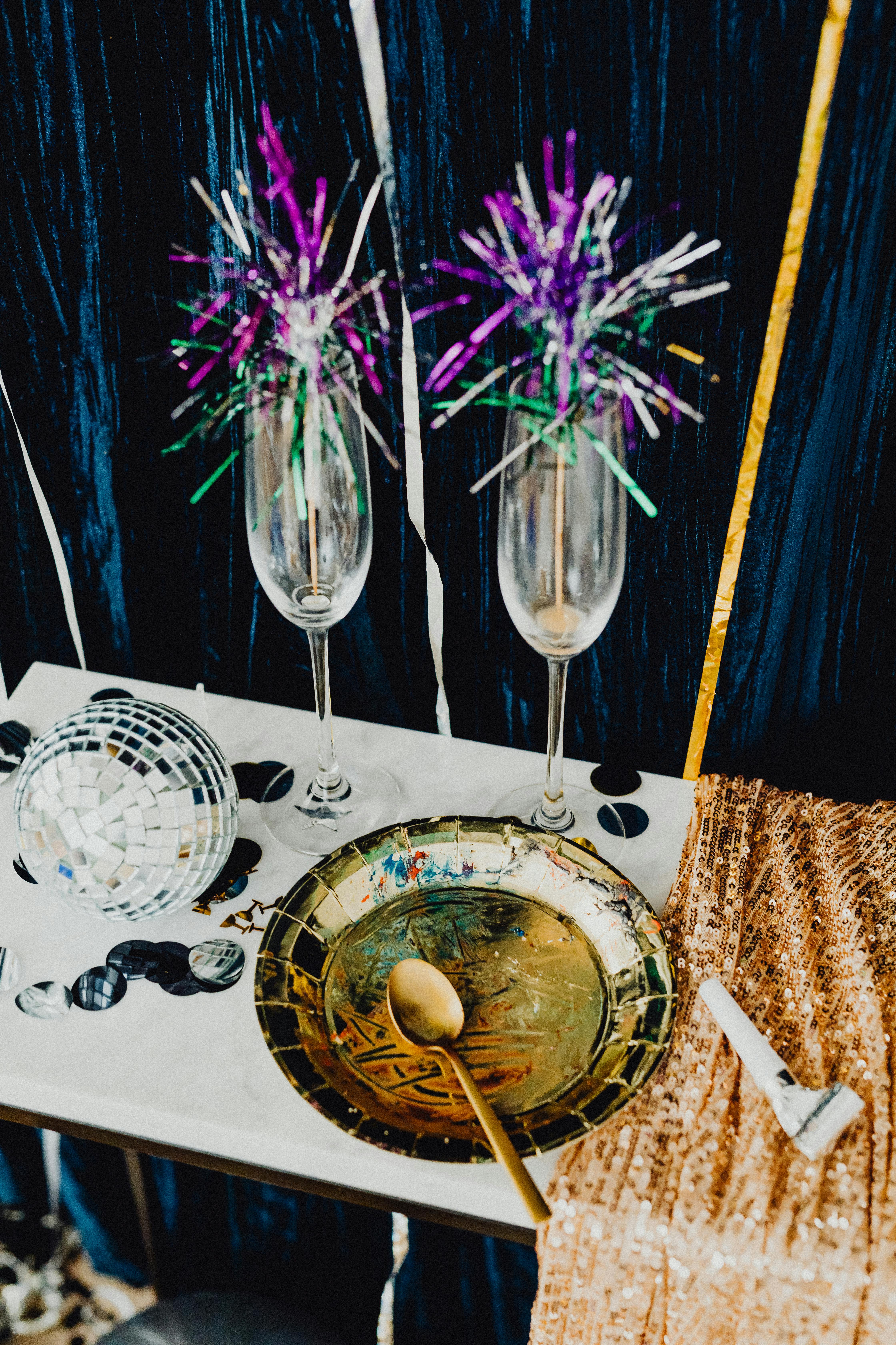 clear drinking glass beside white ceramic round plate on table