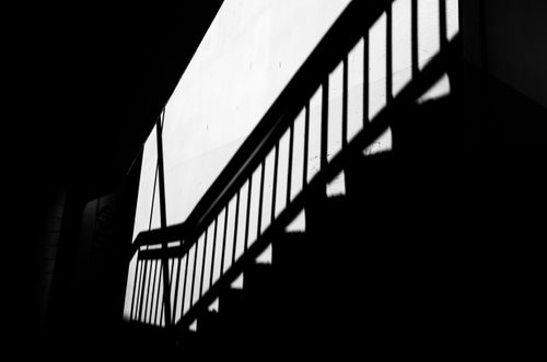 Free Monochrome photo of staircase shadows creating geometric patterns on a wall. Stock Photo