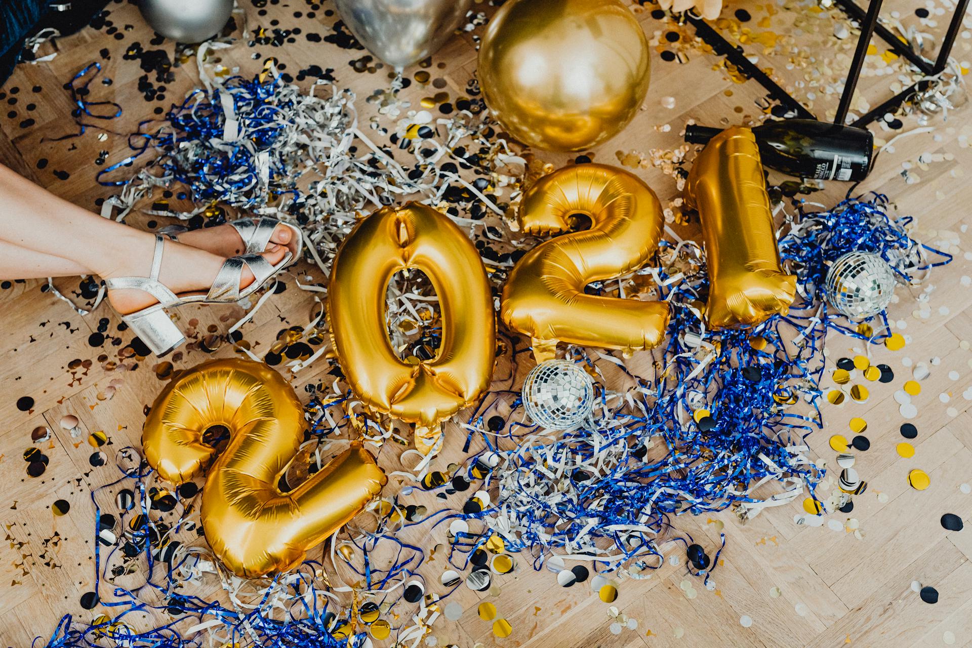 Vibrant new year celebration scene with 2021 balloons, confetti, and party decor.