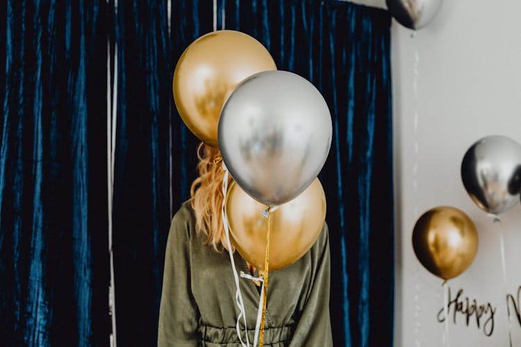 Woman Hiding Behind Balloons At A Party