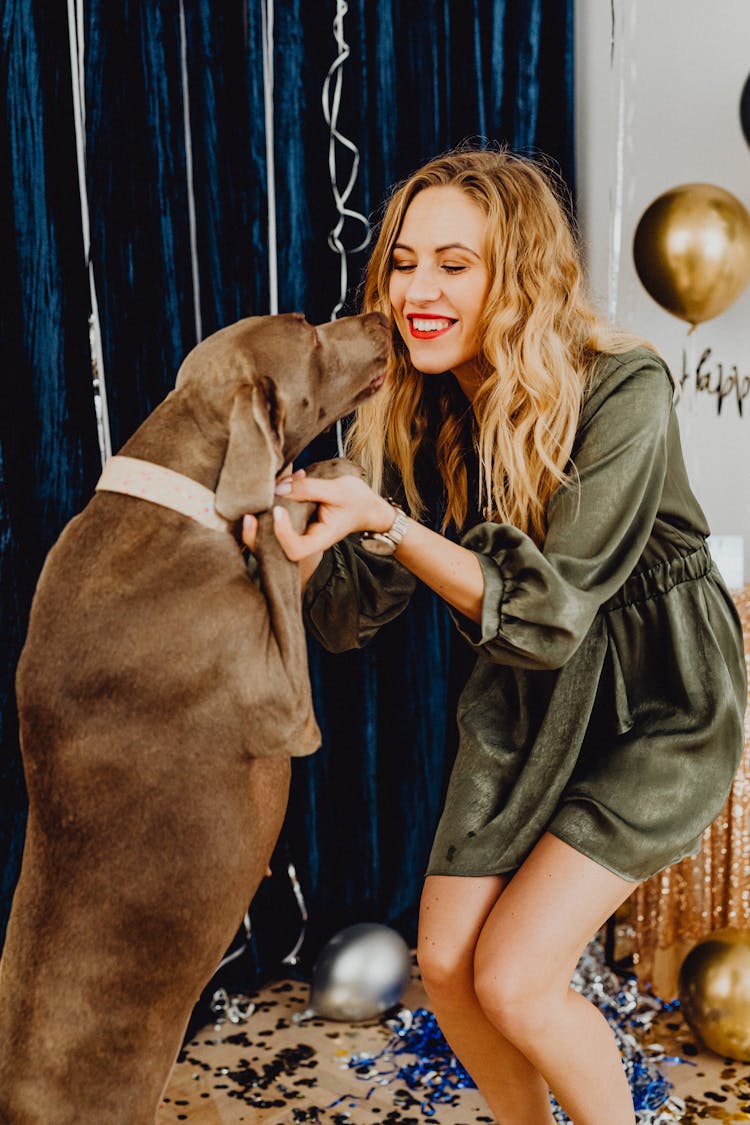 Woman Dancing With Dog On New Years Eve