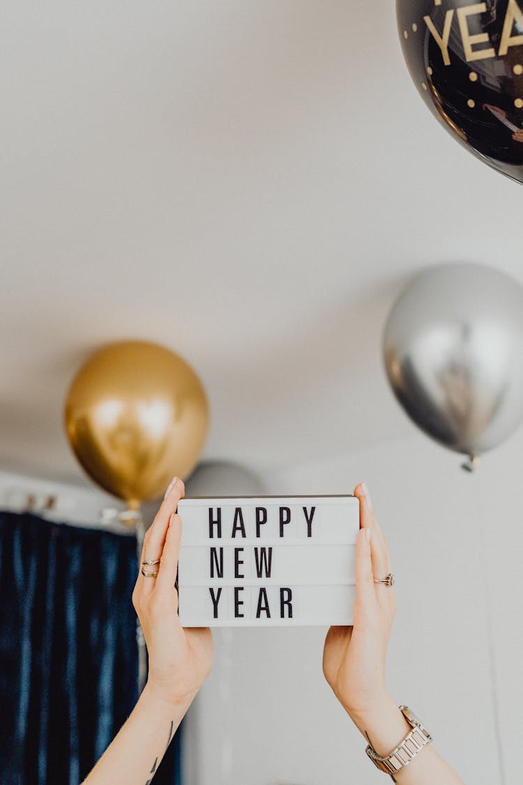 Hands Holding Happy New Year Sign