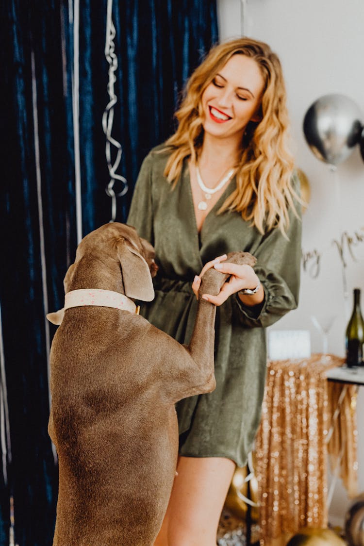 Woman Dancing With Dog At Party