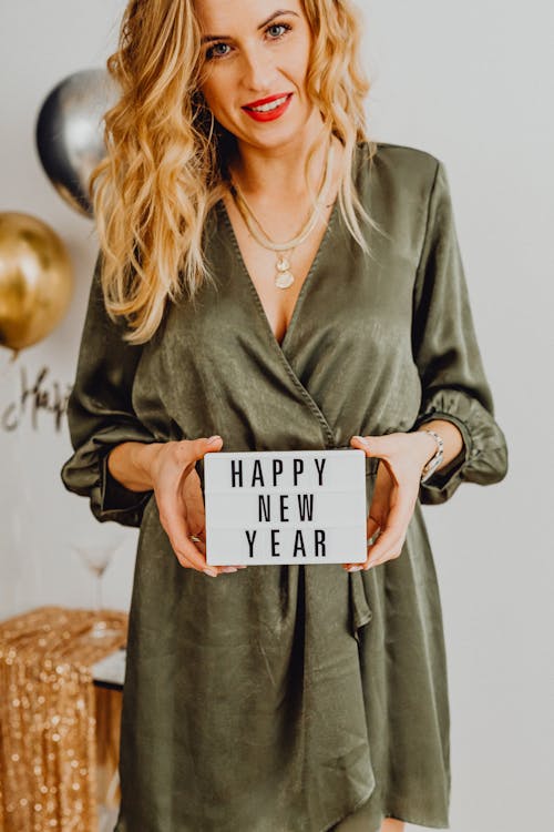 Woman Holding Happy New Year Text