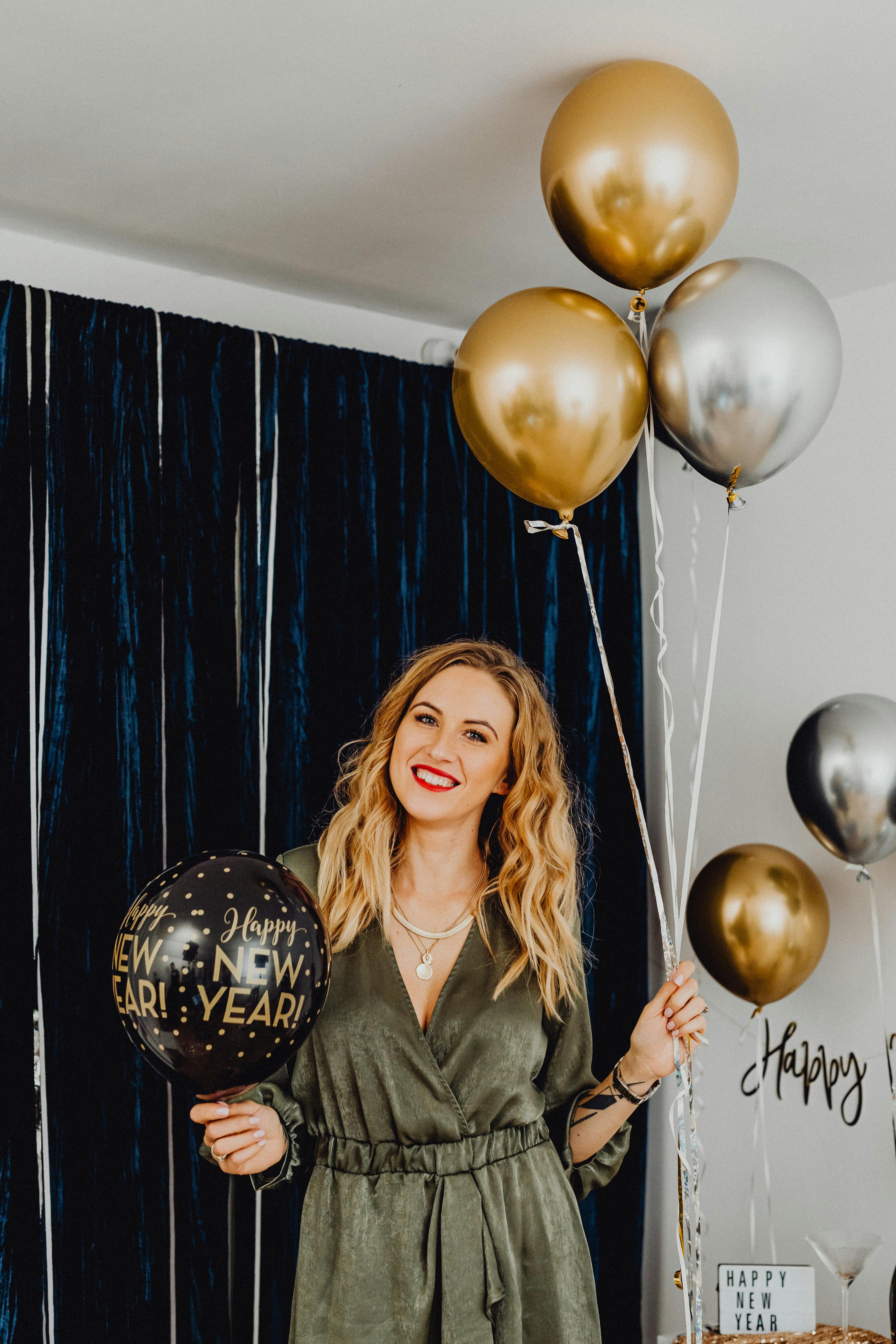 portrait of a woman holding balloons