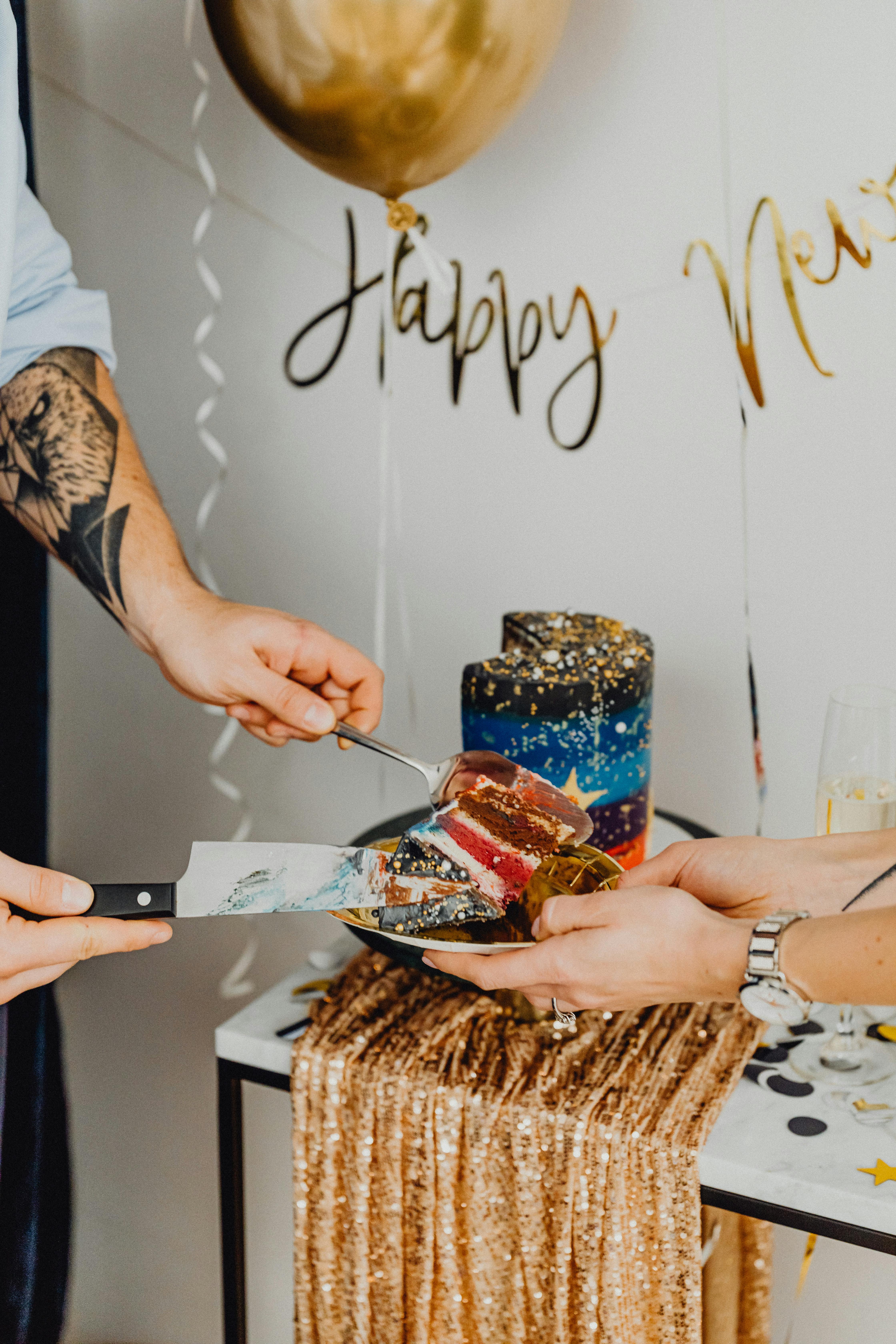 man putting a slice of cake on a plate during new years celebration