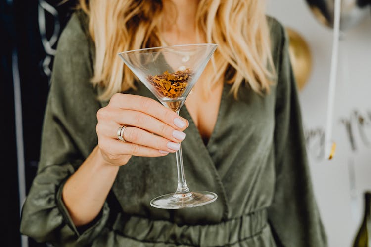 Close-up Of Woman Holding Glass With Glitter