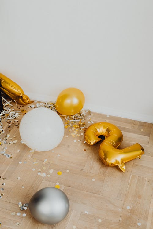 Confetti and Balloons Scattered on the Floor 