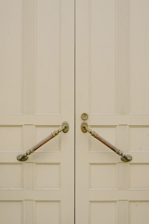 White wooden door with metal handles