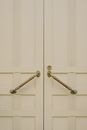 White wooden door with metal handles