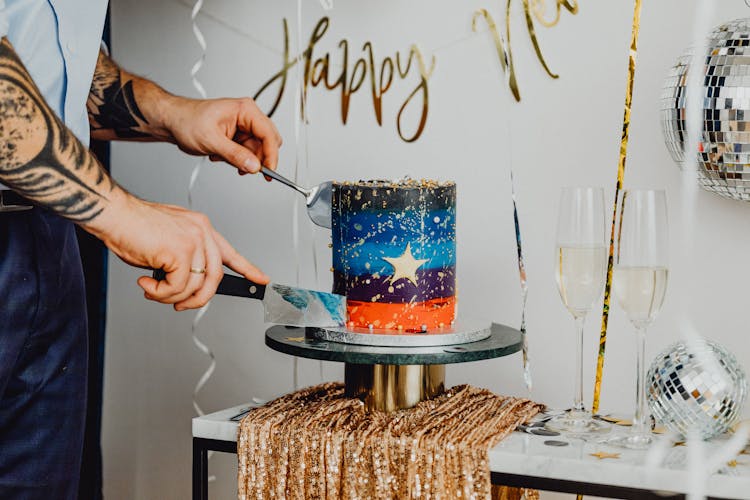 Person Cutting The Cake With Knife