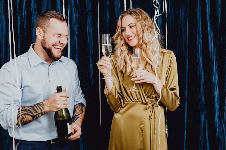 Man And Woman Having Fun Drinking Champagne