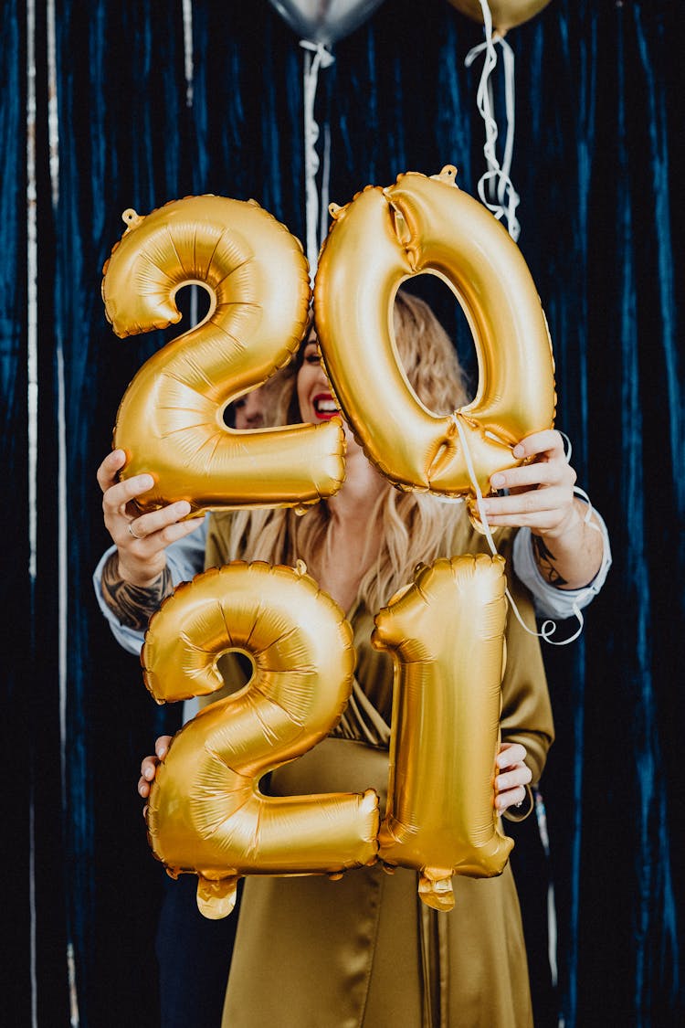 Couple Holding Gold Inflatable Balloons