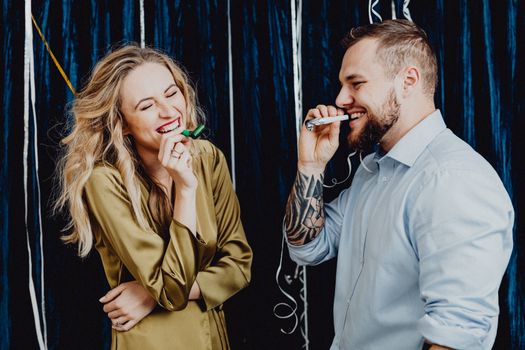 Happy Couple Holding Party Horns