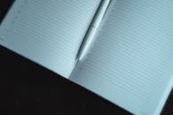 White Pen on Open Notebook