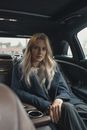 Woman Sitting on the Back Seat of a Car