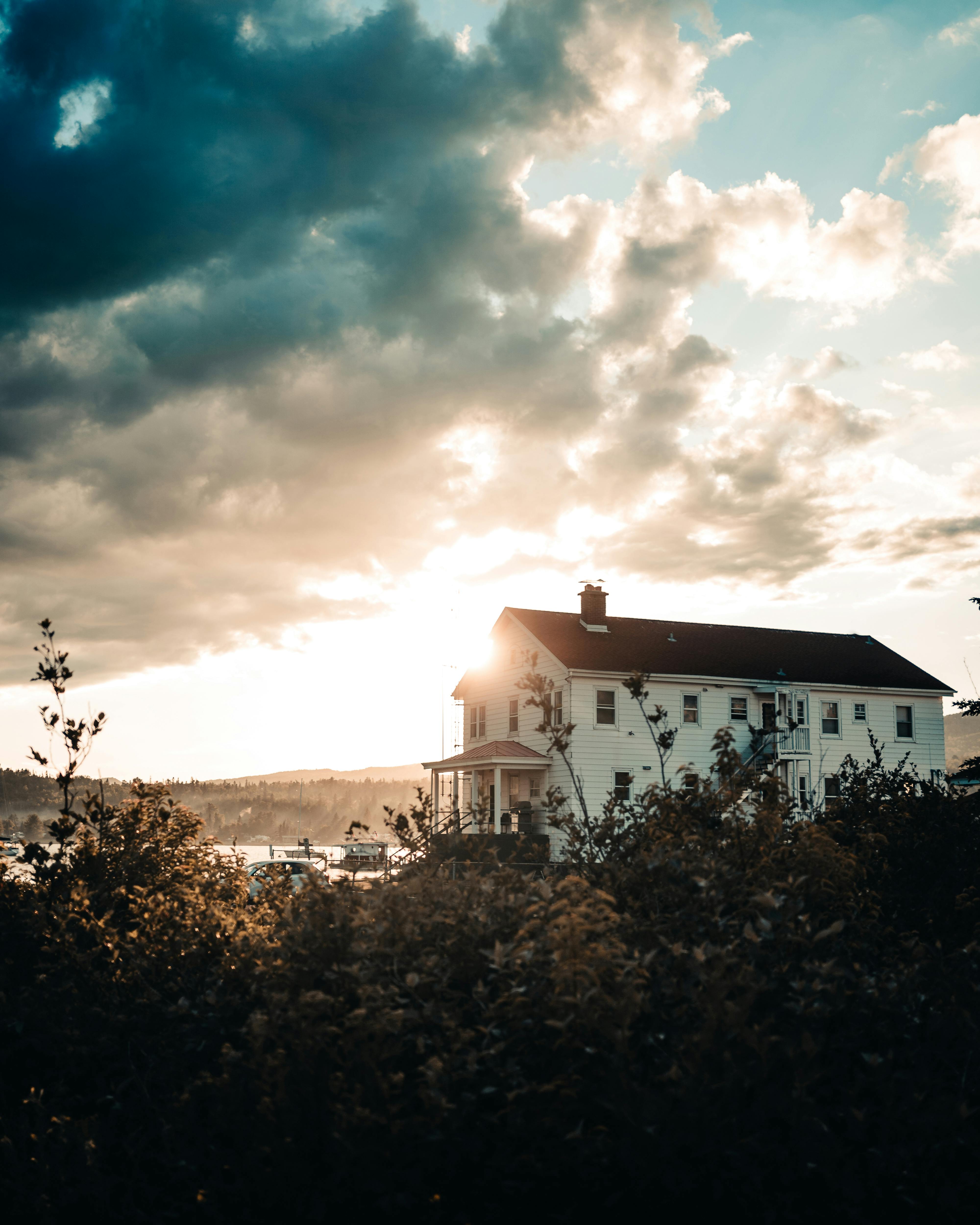 Rural country house on field at sunset · Free Stock Photo