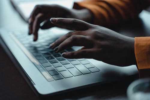 Free Close-up of hands typing on a laptop keyboard, capturing a moment of focused work. Stock Photo