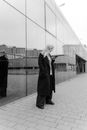 Woman in Black Coat Standing on Sidewalk