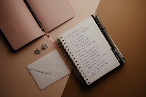 White Notebook on Brown Table