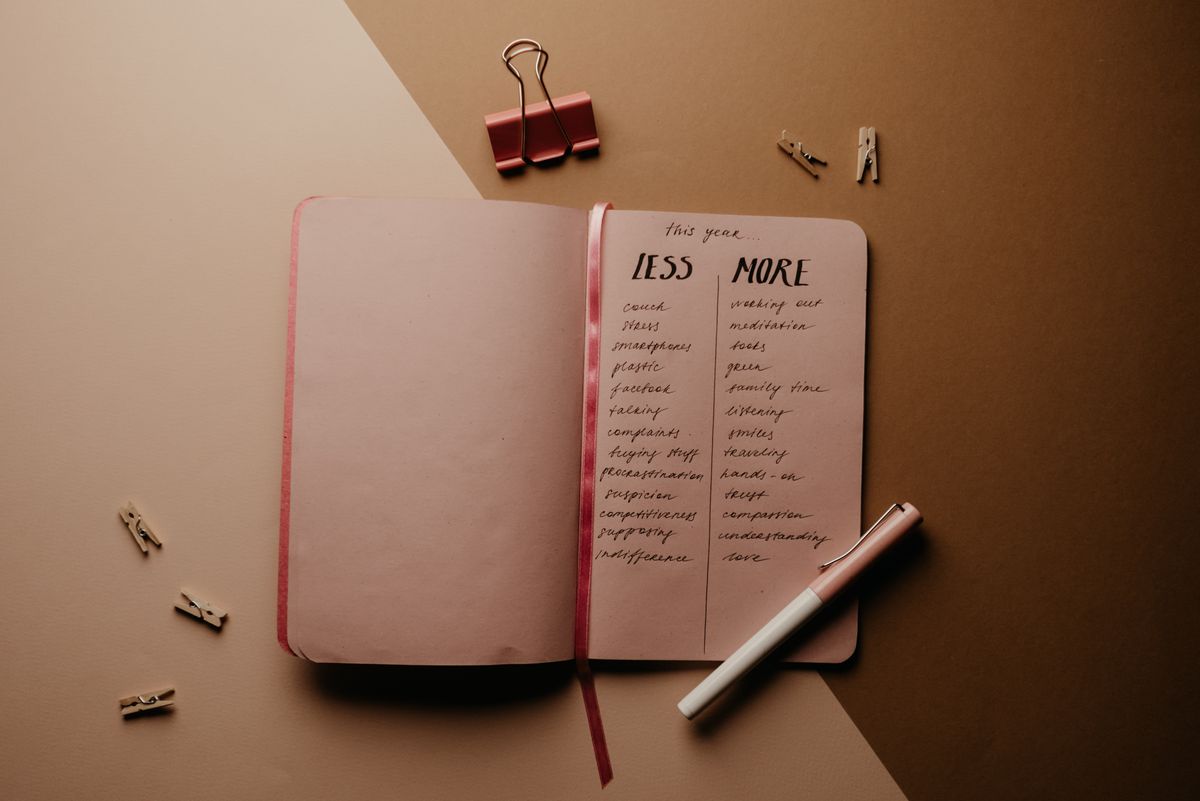 Pink notebook and pen placed neatly on a table for daily writing.