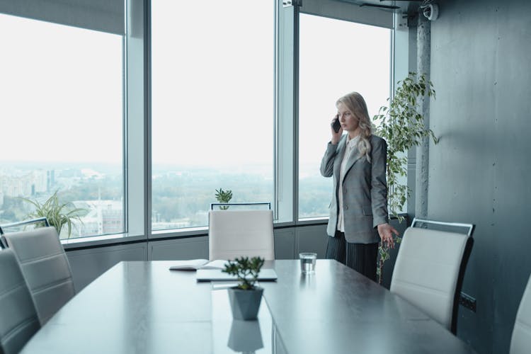 Woman In A Gray Blazer Talking On The Phone