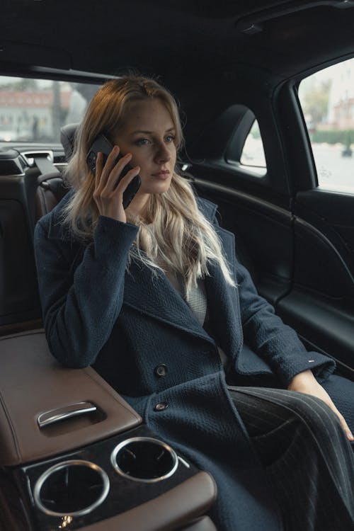 Woman Wearing A Coat Sitting Inside A Car
