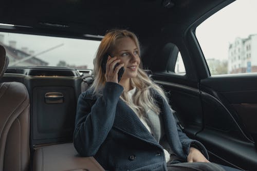 Free Woman Wearing A Coat Sitting Inside A Car Stock Photo