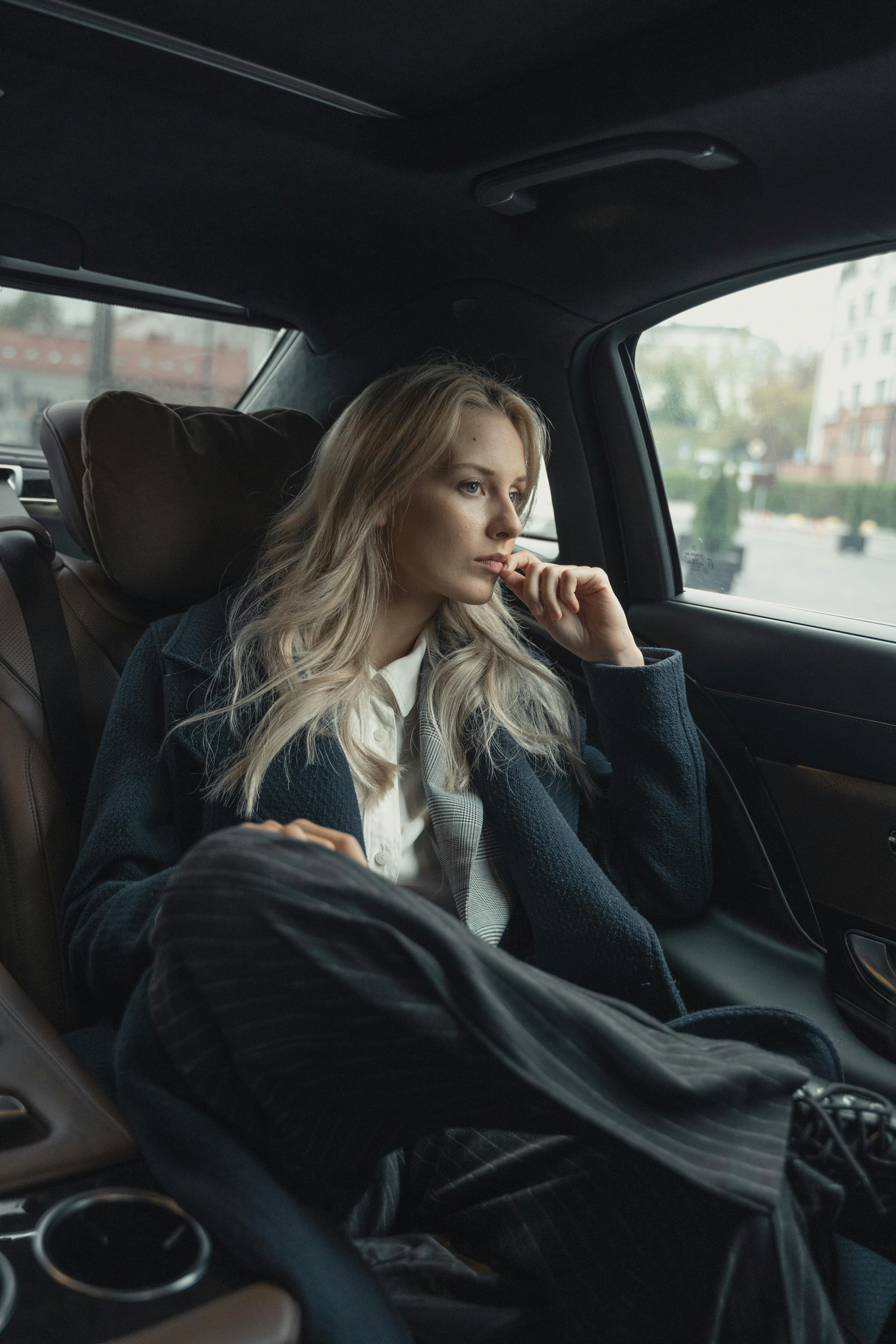 woman in a coat inside a car